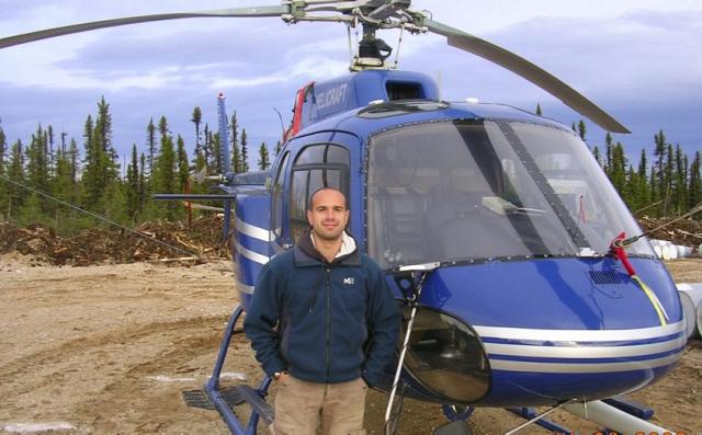 Julien Tramont posant devant son hélicoptère durant son séjour au Canada - Photo DDM